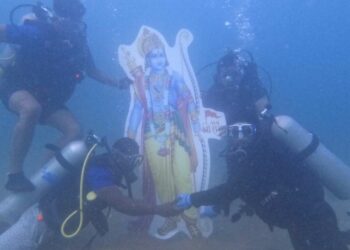 Scuba divers immerse a Ram Idol underwater at Rushikonda